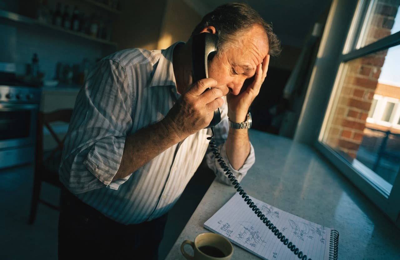 Frustrated homeowner stuck on hold trying to get a roofing quote by phone